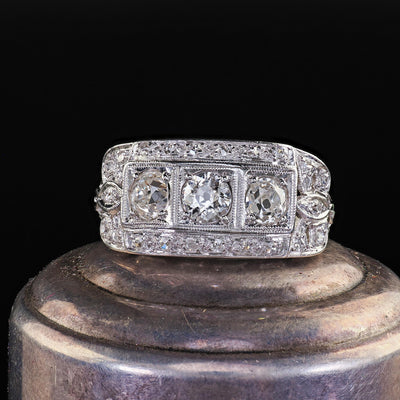 Antique Art Deco Platinum Old Mine Diamond Three Stone Ribbon Motif Ring